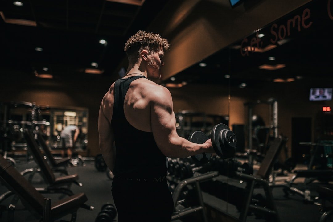 Person doing strength training with weights as part of a healthy exercise routine