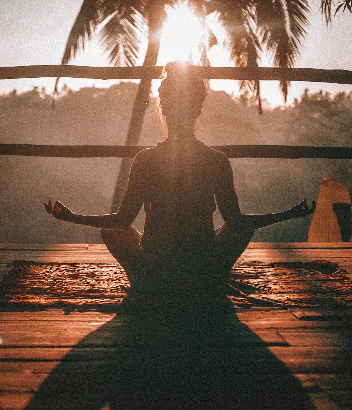 Person meditating peacefully in nature reducing stress